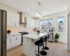 Your UPGRADED chef’s kitchen is a true showstopper, boasting gorgeous cabinetry, quartz countertops, designer tile, an oversized island, modern lighting,  beautiful farmhouse sink, high-end stainless steel appliances, motorized blinds, and large walk-in pantry, etc....