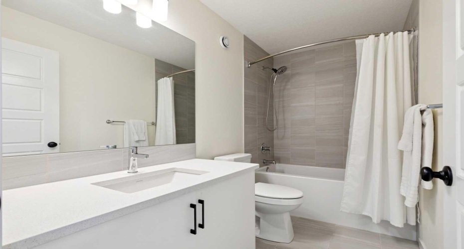 Upper level main 4-pc bath complete with quartz countertops!