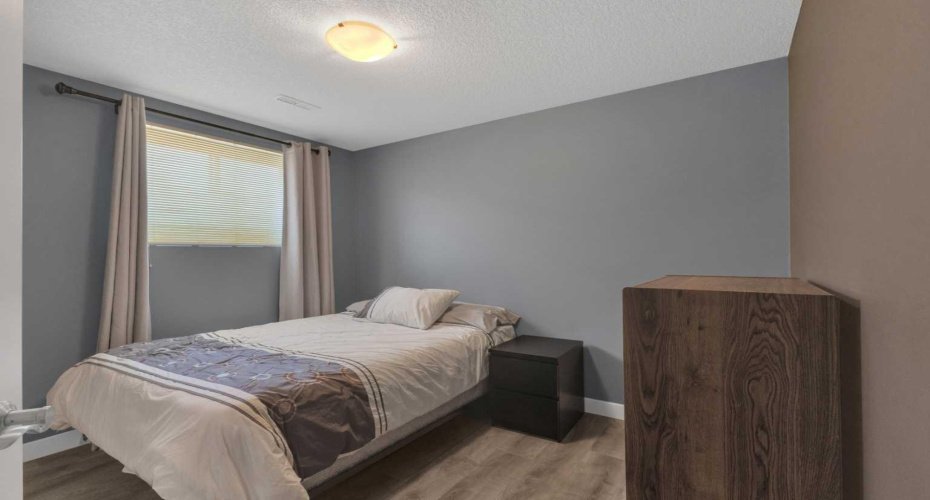 One of two bedrooms in the basement. Notice the big window!