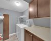Laundry room with more storage and ample space for hanging clothes.