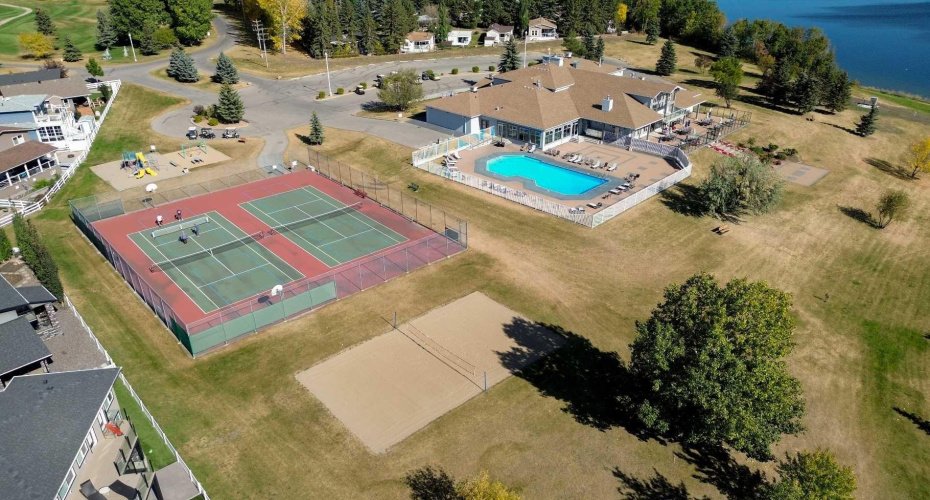 The raquet courts, beach volleyball court, playground, outdoor pool 1 of 2, and the main community building housing the fitness centre, indoor pool and hot tub, restaurant and more.