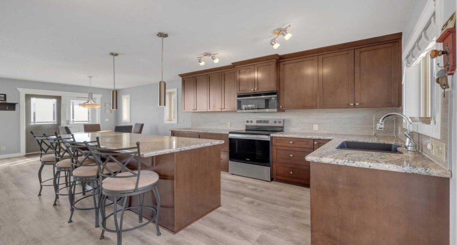 4 appliances in this ample kichen - stove, microwave, dishwasher, and fridge.