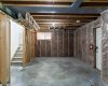 Unfinished basement with 9' ceilings, separate walk-up entrance, rough-in for bathroom & washer/dryer