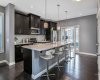 Kitchen features stainless steel appliances, timeless dark cabinets, new dishwasher, under cabinet lighting, island and pantry.