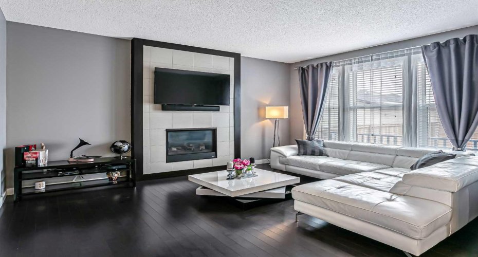 The living room is complimented by a tile surround gas fireplace and can accomodate a variety of furniture options.