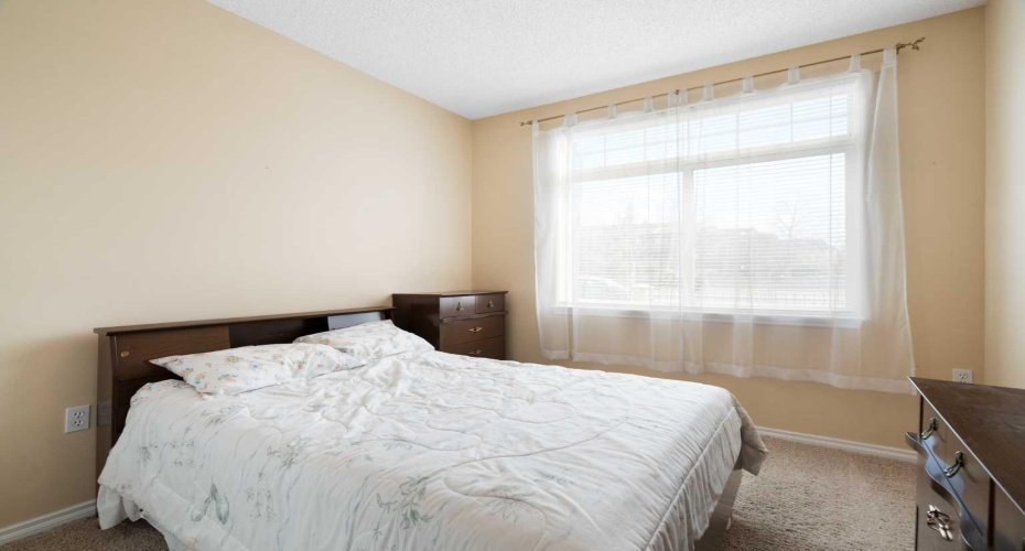 Bedroom, large window, curtains and rod.