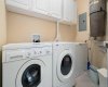 Laundry/storage room, front loading washer and dryer, cabinets, central vacuum.