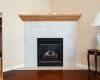 Corner gas fireplace, mantle, tile surround, tile hearth.