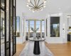 Foyer with double french doors at the end, leading to an expansive entertaining deck.