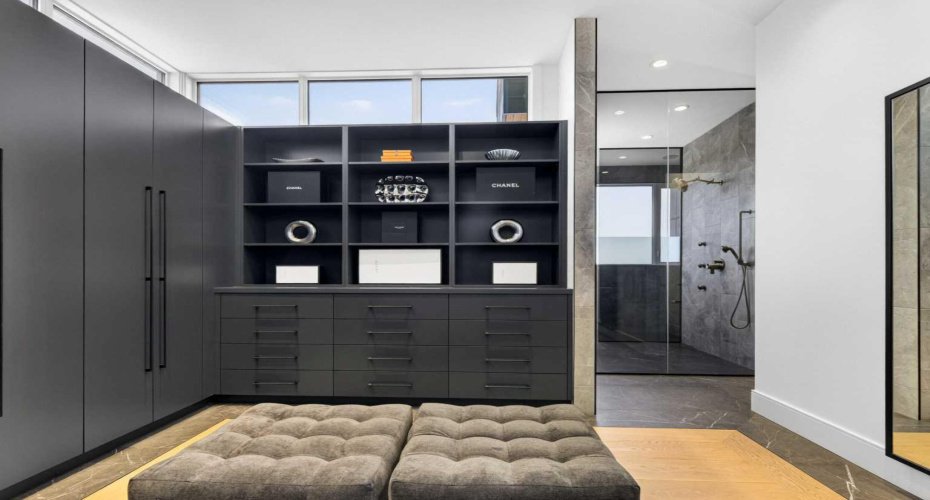 Massive primary walk-in closet that connects directly to the main level laundry room.
