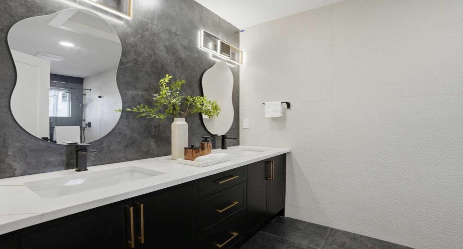 Spa-inspired 4-piece ensuite featuring full-height tile throughout—including side walls—dual vanity, designer fixtures, and a sleek modern finish.