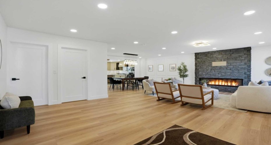 Welcome in through a massive entrance with motion sensor lighting, leading into a stunning open-concept living space with a feature fireplace and modern finishes.