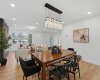 Elegant dining area featuring a statement chandelier, and seamless connection to the bright living space.