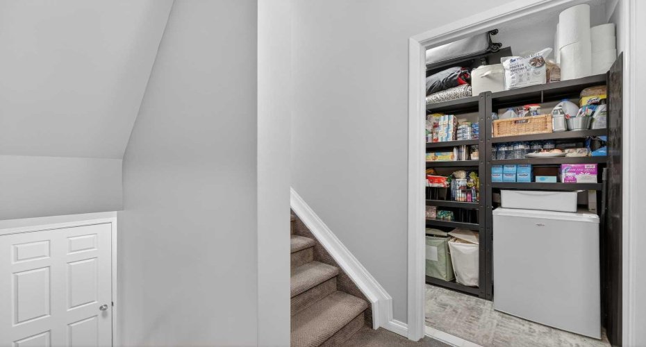 Leading upstairs to the second level, there is ample storage