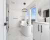 Gorgeous tiled floor, two vanity, and soaker tub
