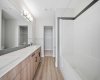 Primary ensuite featuring a dual vanity and modern finishes.