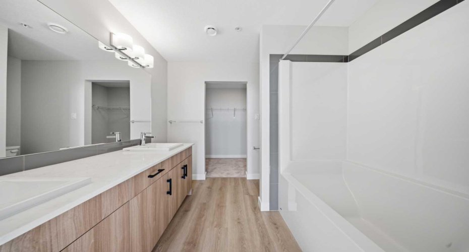 Primary ensuite featuring a dual vanity and modern finishes.