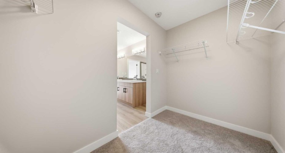 Walk-in closet in the primary bedroom offering ample storage space.