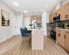Modern kitchen featuring sleek cabinetry, quality finishes, and a functional layout with breakfast bar seating.