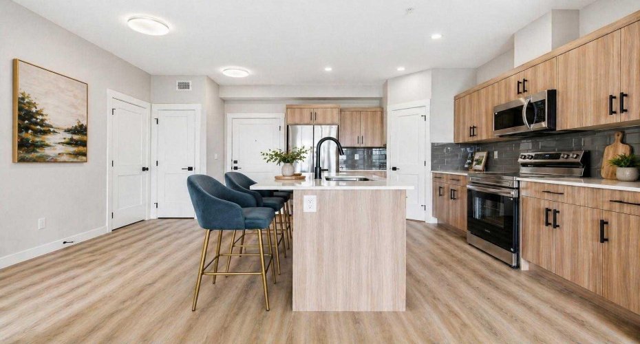 Modern kitchen featuring sleek cabinetry, quality finishes, and a functional layout with breakfast bar seating.