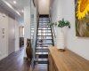 Main floor staircase with view of the elevator to the left