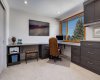 Second bedroom on upper floor, with built in office set up
