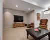 Lower level family room, complete with media speakers and large television
