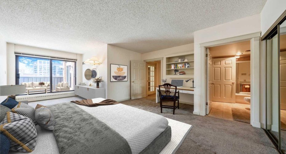 Virtually staged to highlight the spacious second bedroom, complete with a built-in workstation & 4-piece ensuite.