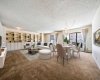 Custom built-in bookshelves are included in the large living & dining room. Virtually staged to highlight how the dining area opens seamlessly to the living room.