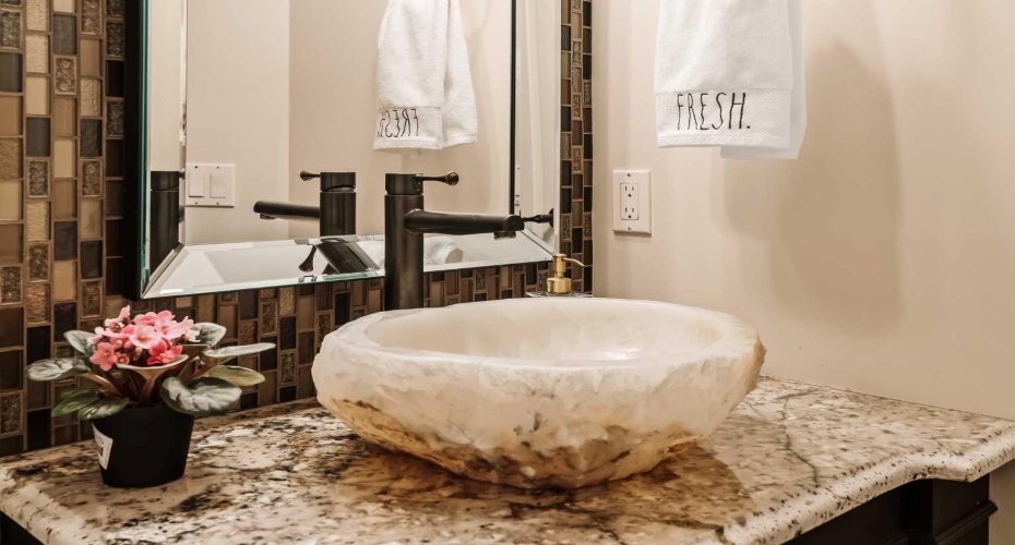 Elegant powder room with artisan vessel sink