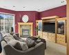 Open and bright lower level family room with third gas fireplace and custom solid maple entertainment center.