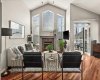 Bright living room anchored with natural gas fireplace, large southwest facing windows and vaulted ceilings.