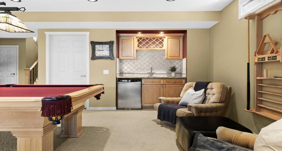 Wet bar complete with sink and beverage fridge.