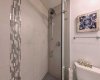 Spa-like details. The luxurious rainfall shower head and sophisticated tile work make the second bathroom feel just as premium as the primary.