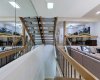 The view from the top. Massive volume and clean sightlines make the home feel expansive and deeply connected.