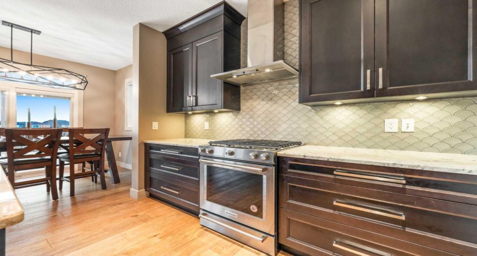 The gorgeous kitchen features quartz countertops, stainless steel appliances, and ceiling-height cabinetry...