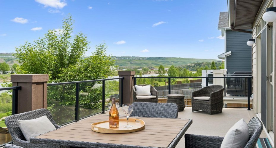 This expansive upper deck is the perfect place to unwind while taking in peaceful Bow River valley views, mature trees, and peek-a-boo mountain vistas. Whether hosting friends or enjoying a quiet evening, the setting feels like a private retreat above the treetops.