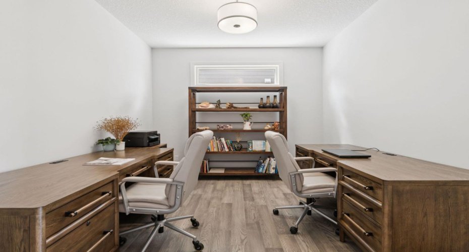 Spacious office on the main floor featuring elegant barn doors to gain privacy in your work space