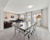 Walkout Basement designed for both relaxation and entertainment, featuring a cozy family area centered around an electric fireplace, along with ample space for a pool table, ping pong, or games area, the perfect extension of the home for family gatherings and entertaining guests.