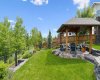 This stunning backyard retreat feels like your own private park, featuring manicured lawns, mature trees, and a custom gazebo designed for outdoor enjoyment