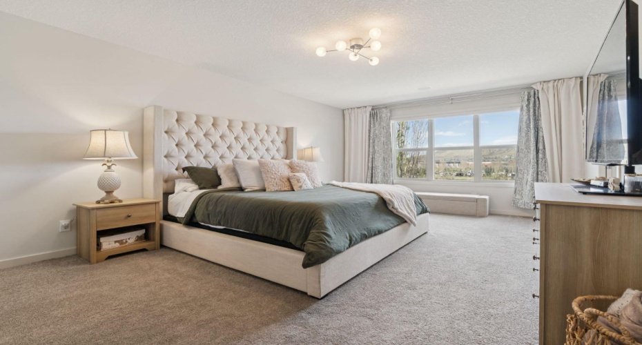 Primary Bedroom with Oversized Windows and River Views right from your bed