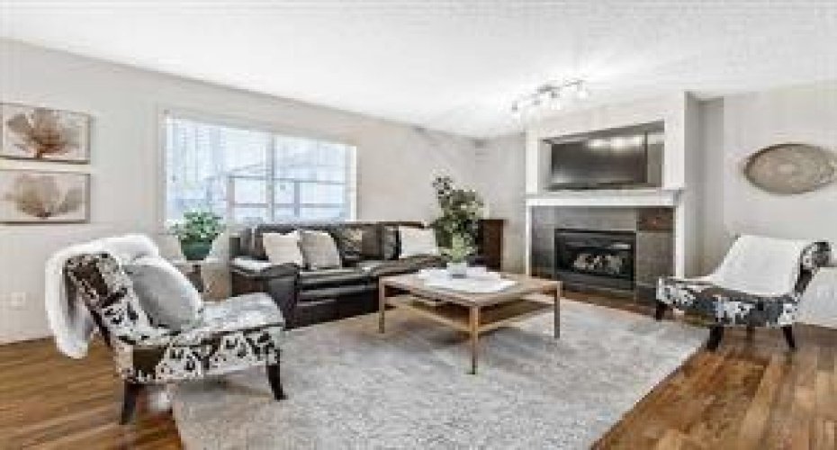 Open concept living room with cozy gas burning mantle fireplace