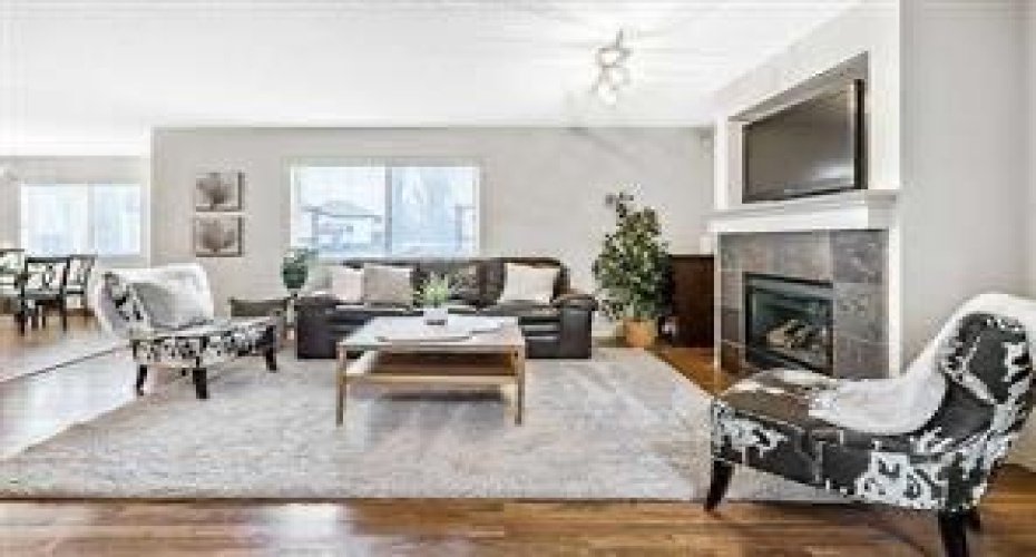 Main level Living room, complimented with gas burning mantle fireplace and durable vinyl flooring