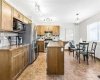 Modern kitchen with SS appliances, breakfast bar and eating area