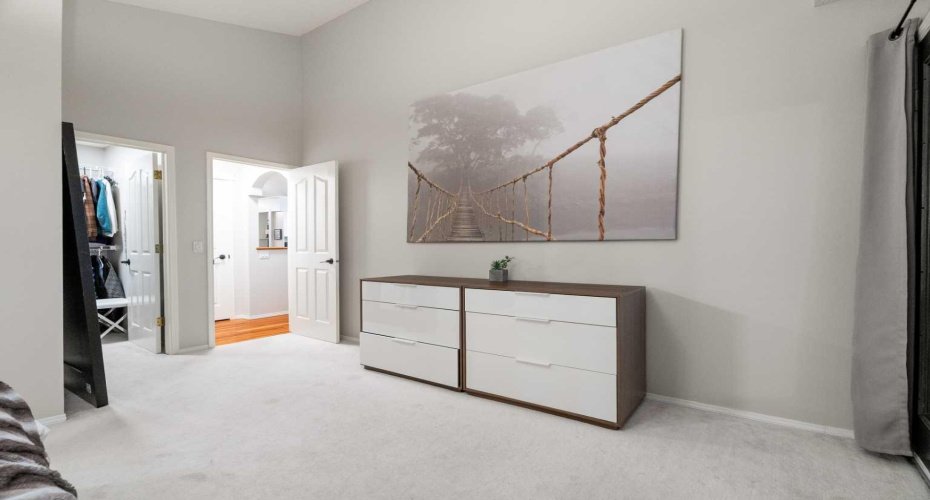 A unique bungalow layout includes three bedrooms on the main level, each positioned off separate coves and hallways, keeping them tucked away from the main living areas.