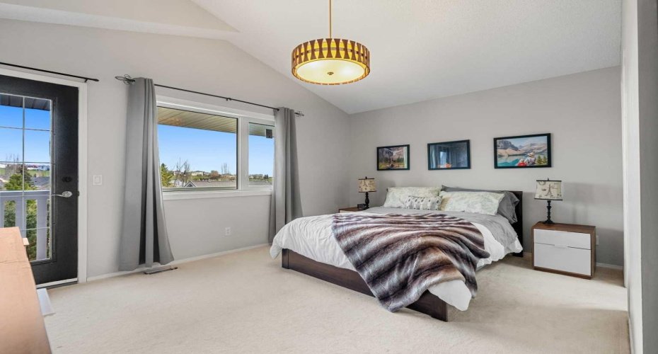 The king-size primary suite offers a private escape with vaulted ceilings, new  Low E-glass window and a large walk-in closet with organizers.