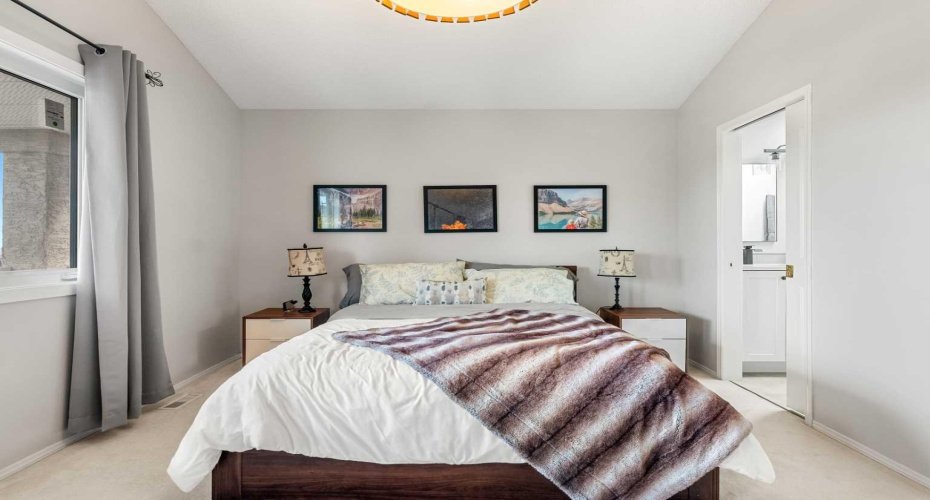 The king-size primary suite offers a private escape with vaulted ceilings, new  Low E-glass window and a large walk-in closet with organizers.