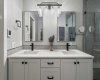 The beautifully renovated ensuite (2024) features dual vanities, heated floors, a spa-inspired shower, and a skylight that enhances the space with natural light.