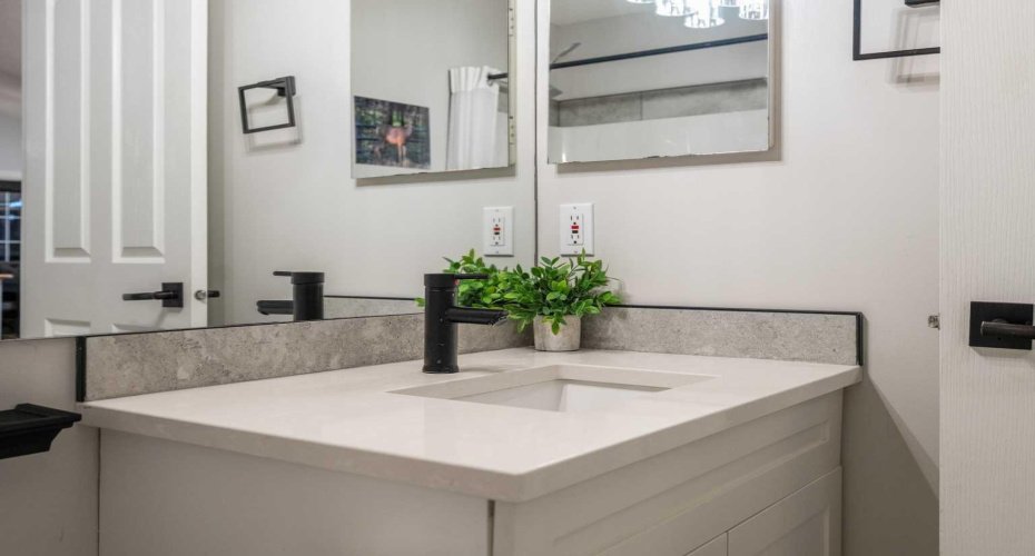 Updated 4 piece main bathroom with under cabinet lighting and a design palette that carries through the home