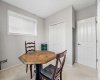 A spacious bedroom with two large windows overlooks the backyard